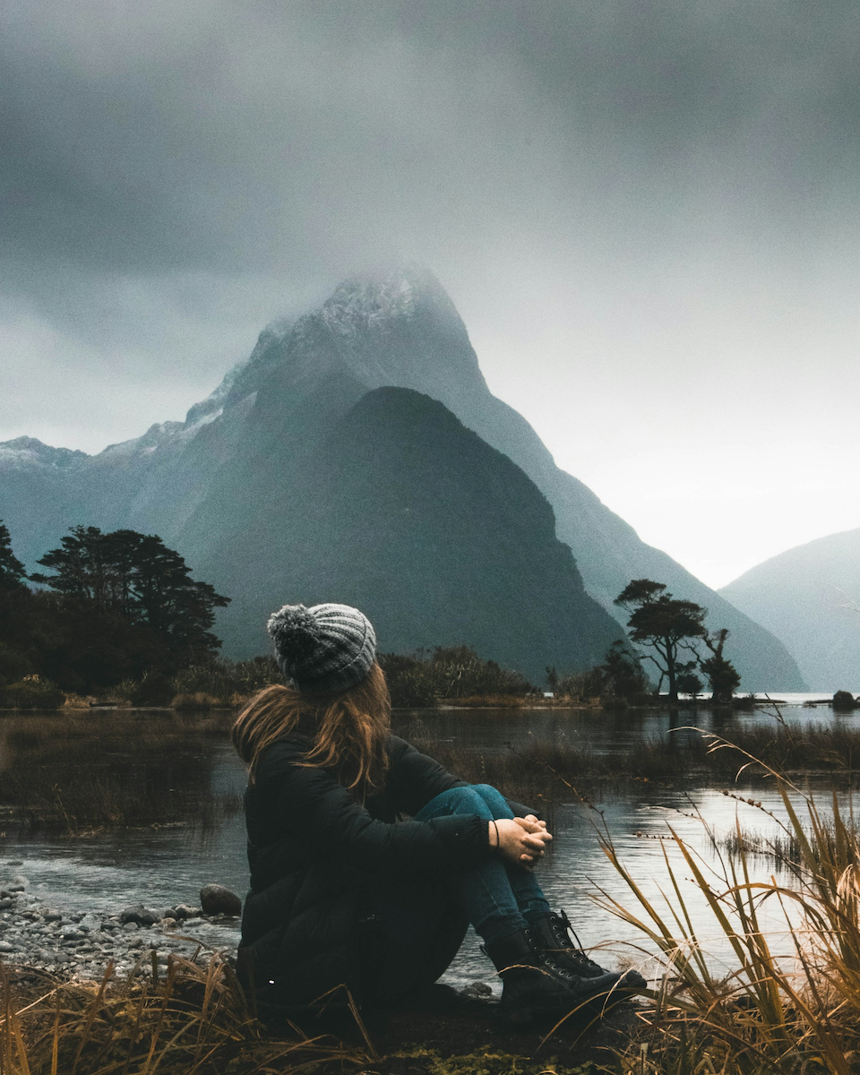 Femail looking at mountain top from Sound, New Zealand